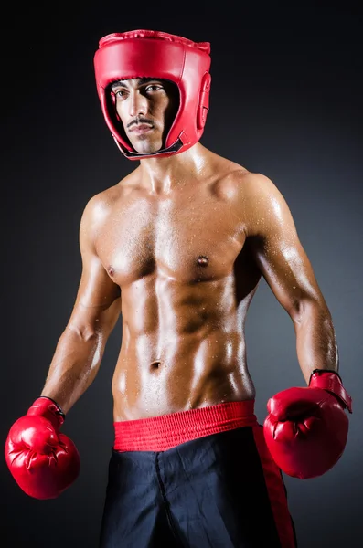 Boxer with red gloves in dark room — Stock Photo, Image