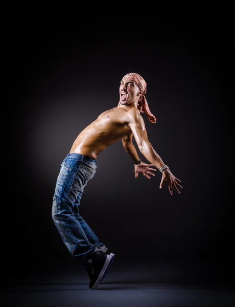 Dancer dancing in the dark studio — Stock Photo, Image