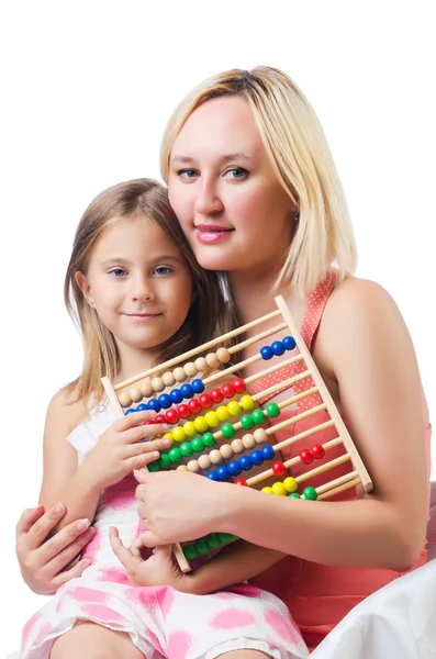 Mother and daughter with abacus on white — Stock Photo, Image