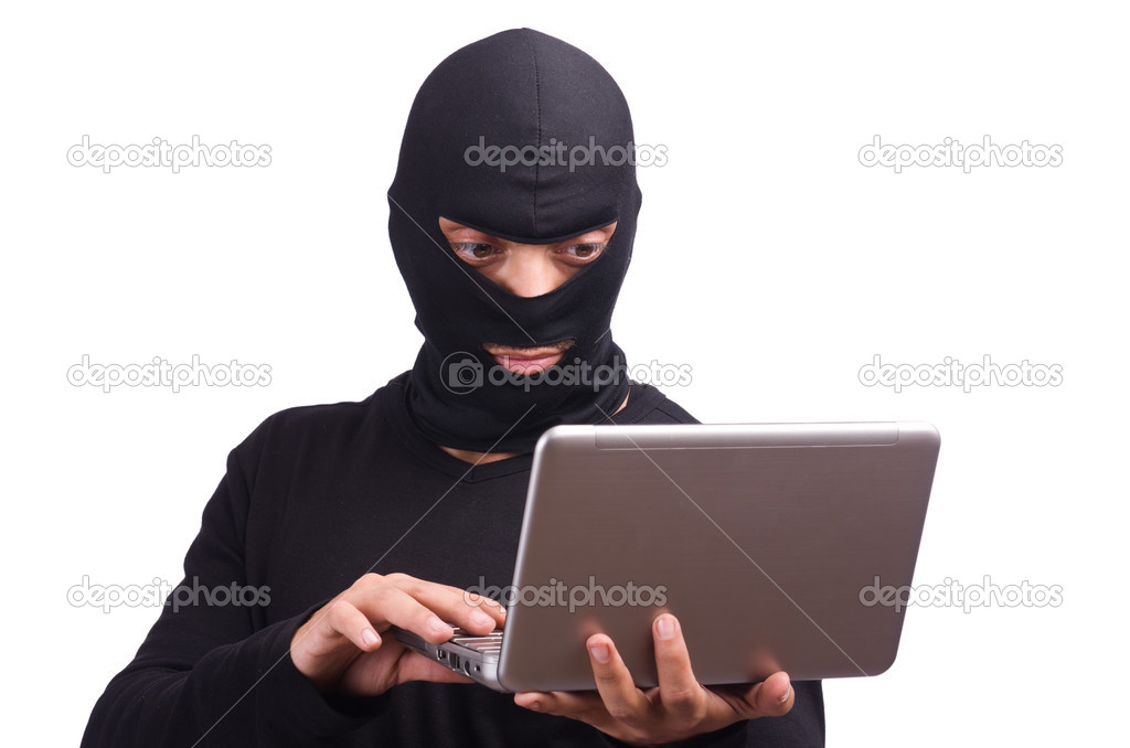 Hacker with computer wearing balaclava