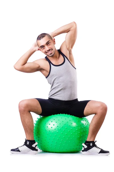 Homem com bola suíça fazendo exercícios em branco — Fotografia de Stock
