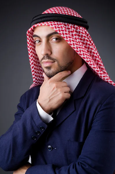 Arab businessman in dark studio — Stock Photo, Image