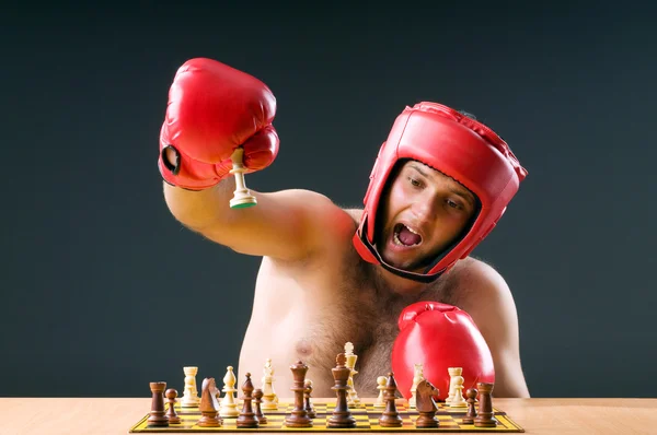 Boxer stuggling with chess game — Stock Photo, Image