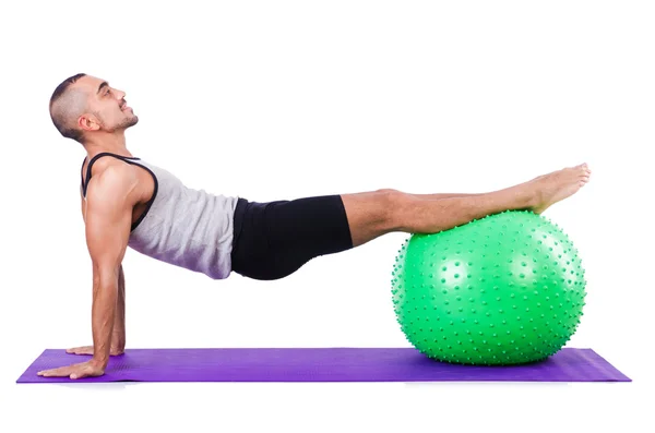 Hombre con pelota suiza haciendo ejercicios en blanco —  Fotos de Stock