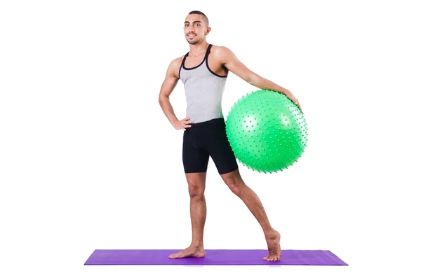 Homem com bola suíça fazendo exercícios em branco — Fotografia de Stock