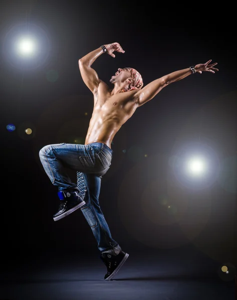 Dancer dancing in the dark studio — Stock Photo, Image