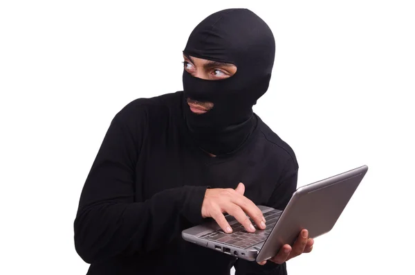 Hacker with computer wearing balaclava — Stock Photo, Image