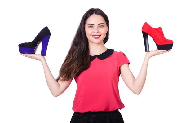 Young woman with choice of shoes on white — Stock Photo, Image