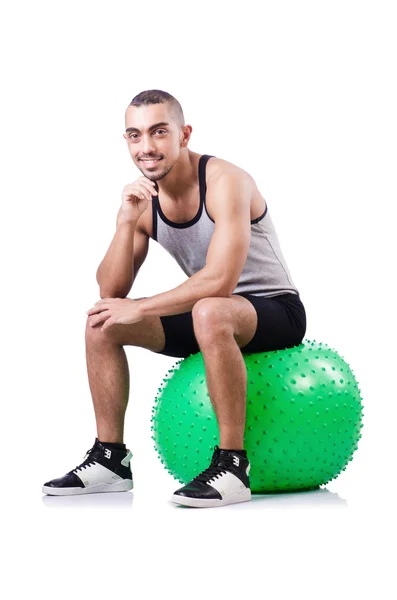 Hombre con pelota suiza haciendo ejercicios en blanco —  Fotos de Stock