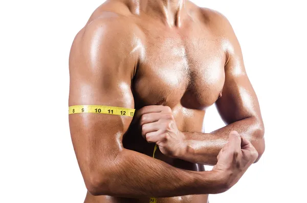 Homem muscular medindo seus músculos — Fotografia de Stock