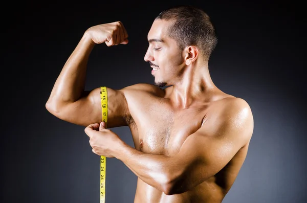 Pria berotot yang mengukur ototnya — Stok Foto