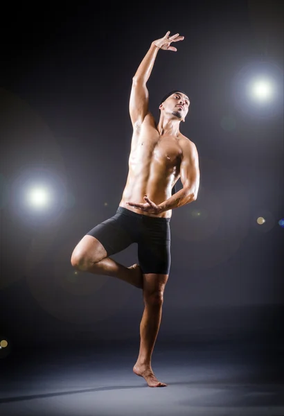 Dancer dancing in the dark studio — Stock Photo, Image