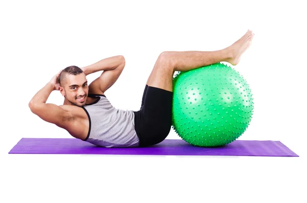 Homem com bola suíça fazendo exercícios em branco — Fotografia de Stock