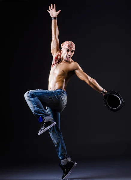 Dancer dancing in the dark studio — Stock Photo, Image