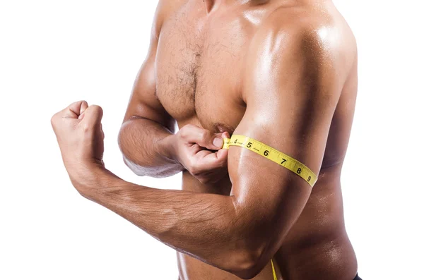 Muscular man measuring his muscles — Stock Photo, Image