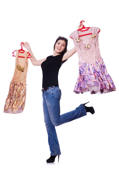 Mulher tentando escolher o vestido no branco — Fotografia de Stock