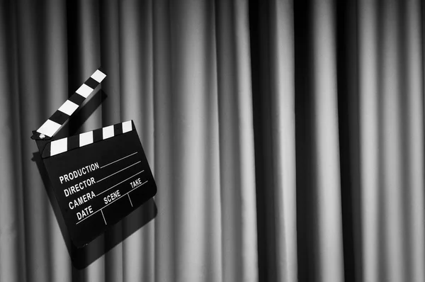 Movie clapper board against curtain