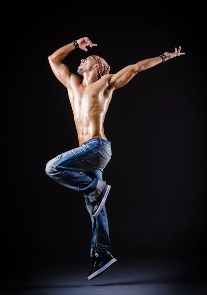 Dancer dancing in the dark studio — Stock Photo, Image