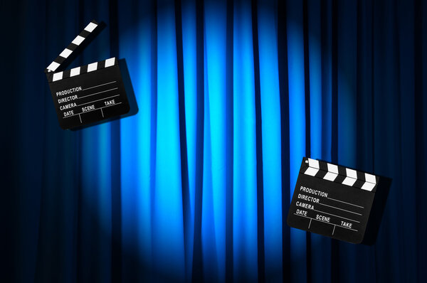 Movie clapper board against curtain