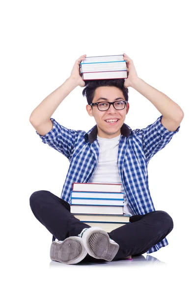 Student mit vielen Büchern auf weiß — Stockfoto