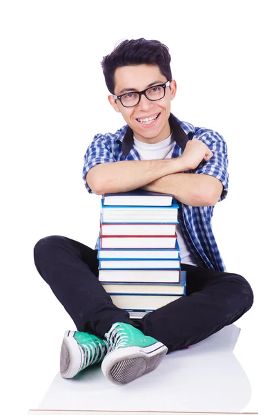 Student mit vielen Büchern auf weiß — Stockfoto