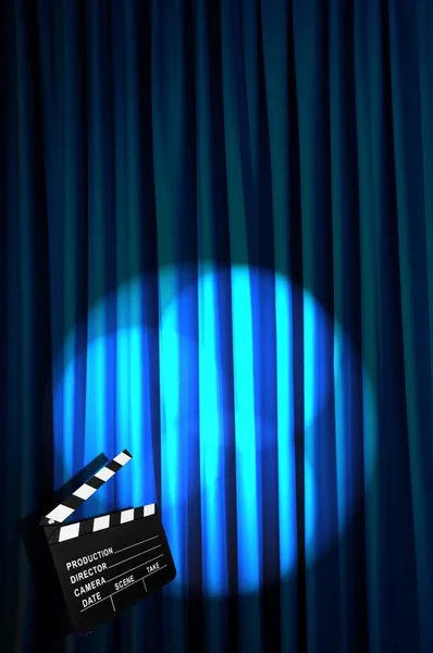 Movie clapper board against curtain