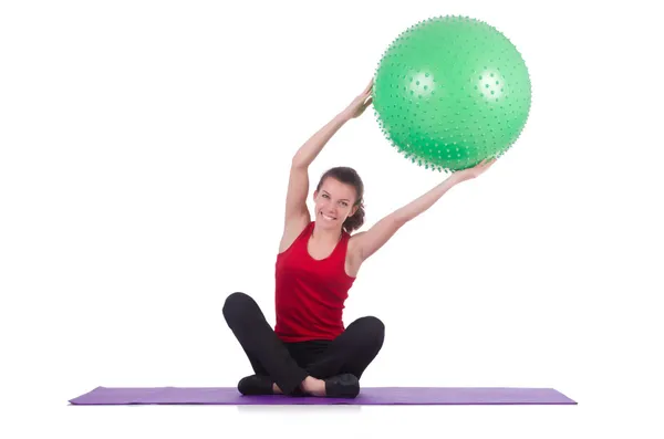 Young woman with ball exercising on white — Stock Photo, Image