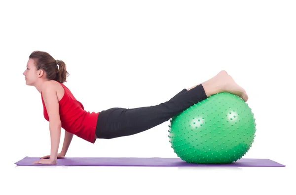 Young woman with ball exercising on white — Stock Photo, Image