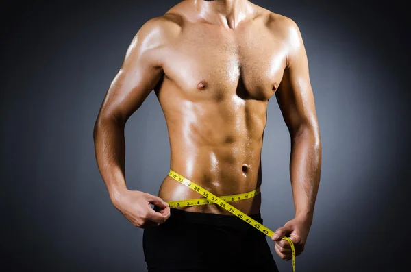 Muscular man measuring his muscles — Stock Photo, Image