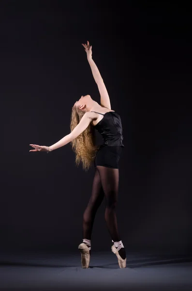 Ballerina dancing in the dark studio Royalty Free Stock Photos