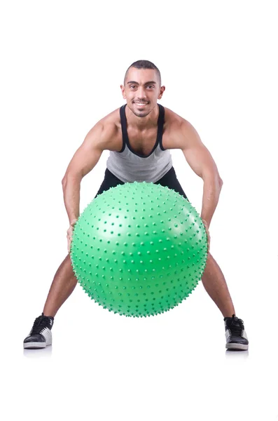 Homem com bola suíça fazendo exercícios em branco — Fotografia de Stock