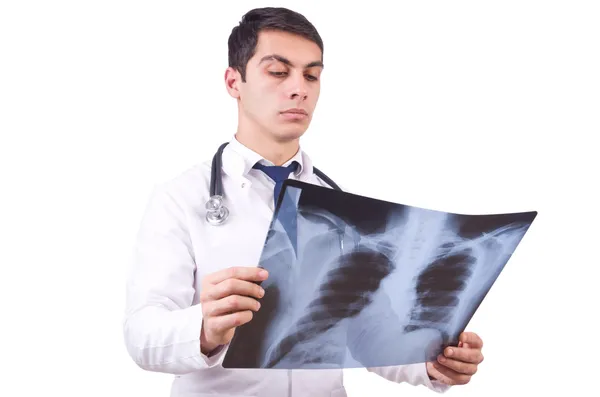 Молодой врач с рентгеновским снимком на белом — стоковое фото