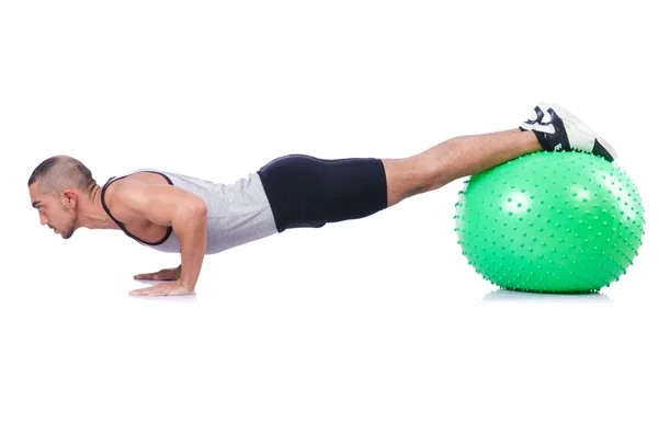 Hombre con pelota suiza haciendo ejercicios en blanco — Foto de Stock