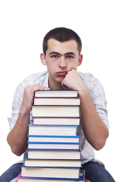 Студент з великою кількістю книг на білому — стокове фото