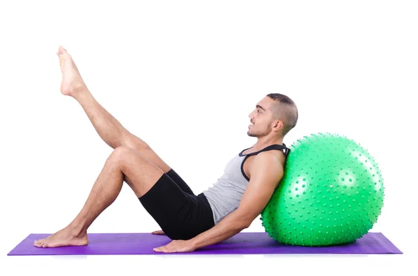 Hombre con pelota suiza haciendo ejercicios en blanco —  Fotos de Stock