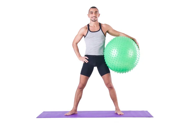 Hombre con pelota suiza haciendo ejercicios en blanco —  Fotos de Stock