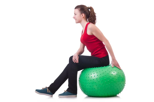 Mujer joven con pelota haciendo ejercicio sobre blanco —  Fotos de Stock