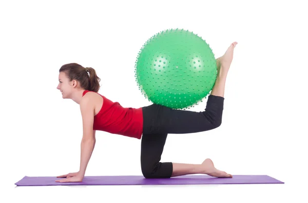 Young woman with ball exercising on white — Stock Photo, Image