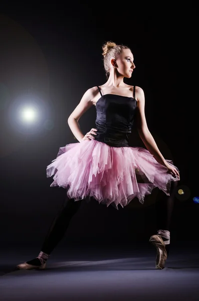 Ballerina dancing in the dark studio — Stock Photo, Image