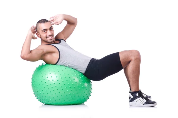 Hombre con pelota suiza haciendo ejercicios en blanco — Foto de Stock