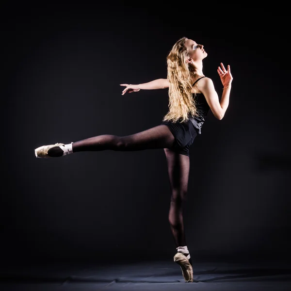 Ballerina dancing in the dark studio — Stock Photo, Image