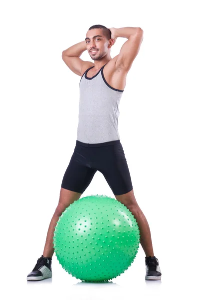 Hombre con pelota suiza haciendo ejercicios en blanco —  Fotos de Stock