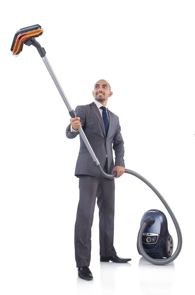 Businessman doing vacuum cleaning on white — Stock Photo, Image