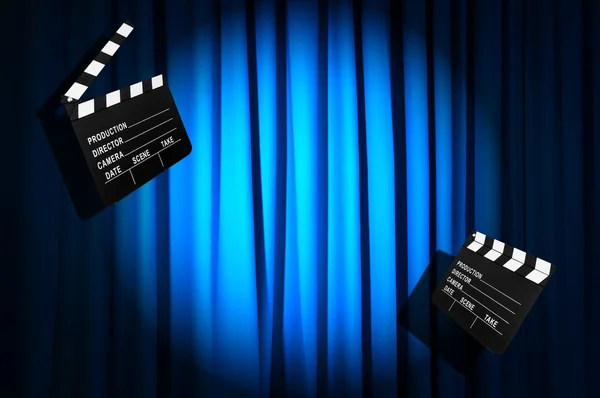 Movie clapper board against curtain