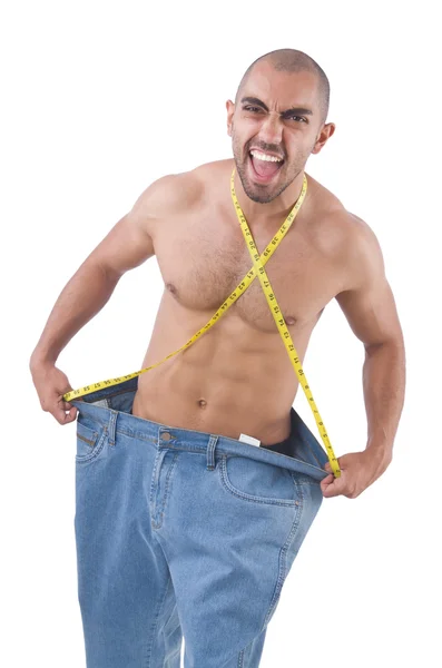 Homem em dieta conceito com jeans de grandes dimensões — Fotografia de Stock