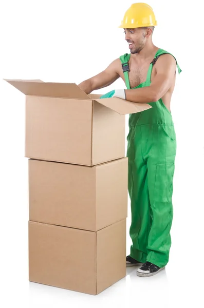 Hombre en mono verde con cajas — Foto de Stock