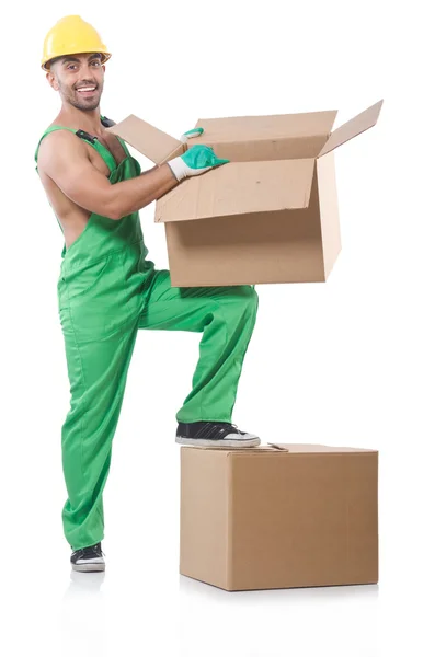 Чоловік в зеленому комбінезоні з коробками — стокове фото