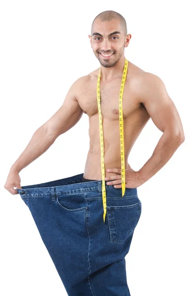 Muž v dietě koncept s nadrozměrných džíny — Stock fotografie