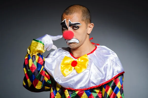 Sad clown against dark background — Stock Photo, Image