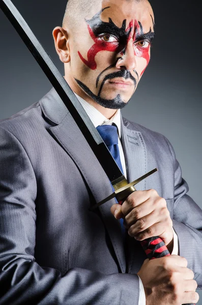 Man with face paint and sword — Stock Photo, Image